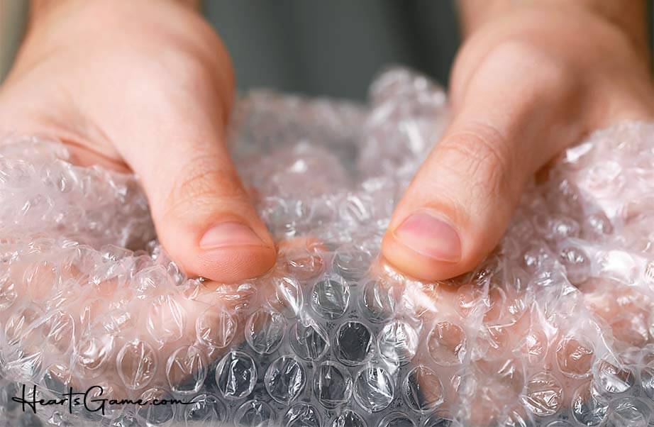 Fingers popping bubble wrap